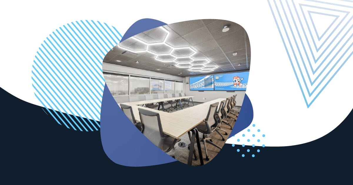 Modern conference room with sleek lighting and dual display screens, representing advanced Microsoft Teams Rooms deployment.