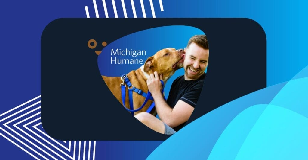 A happy dog licks a smiling man’s face, with the Michigan Humane logo overlaid on a vibrant blue background.
