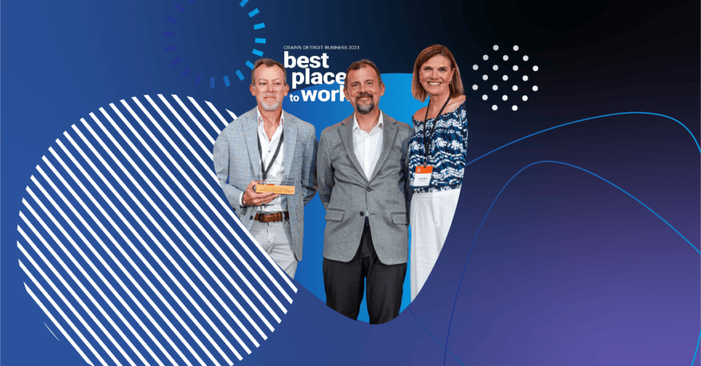 Three Apex Digital team members standing in front of the Crain’s Best Places to Work 2023 sign, smiling and holding a recognition plaque.