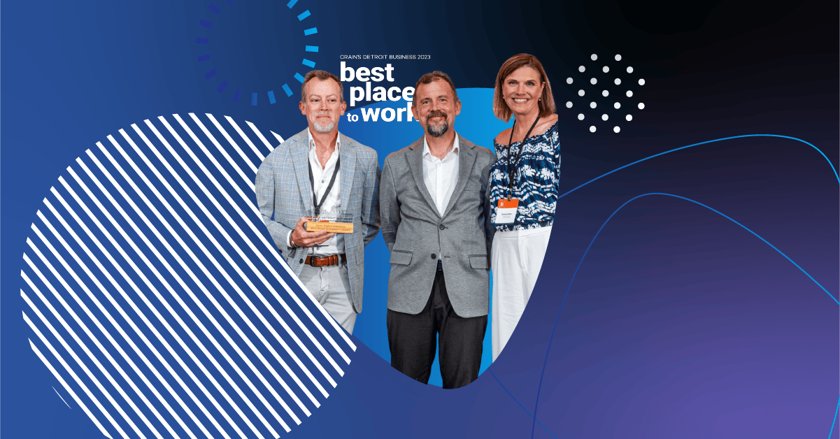 Three Apex Digital team members standing in front of the Crain’s Best Places to Work 2023 sign, smiling and holding a recognition plaque.